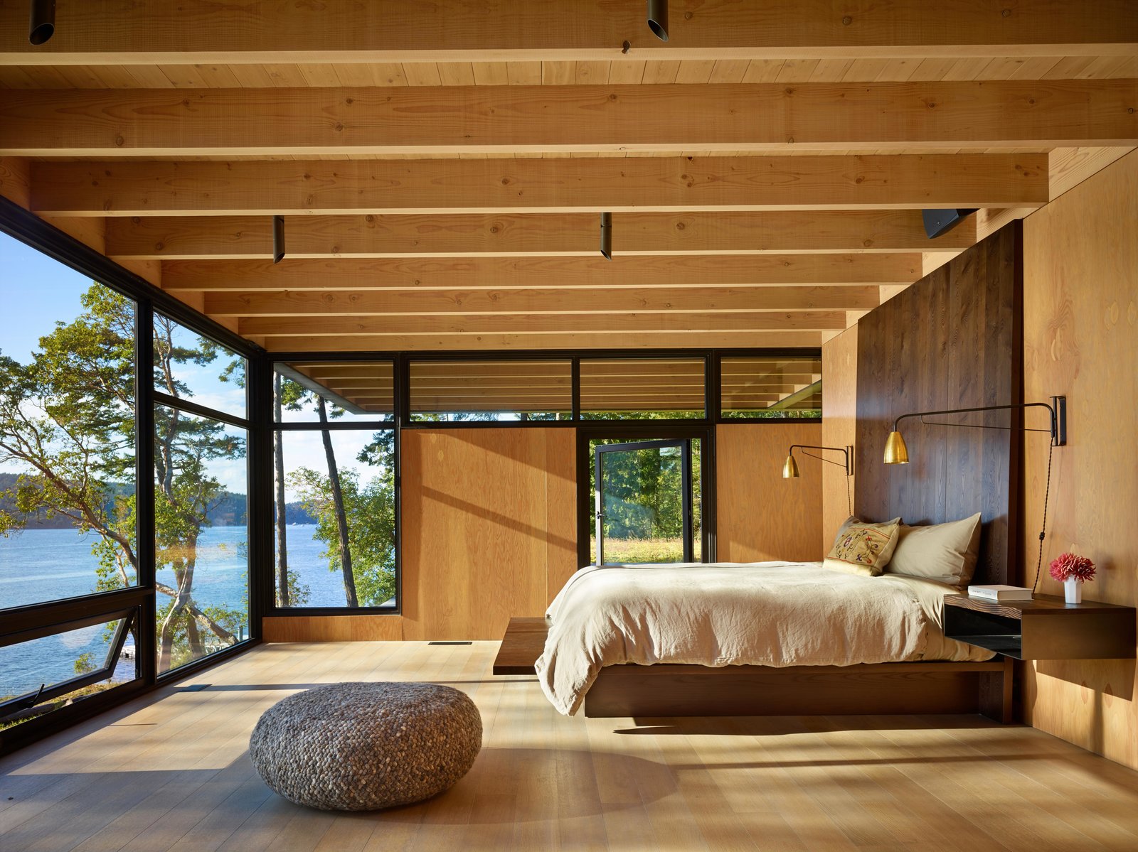 Large wooden bedroom overlooking a lake